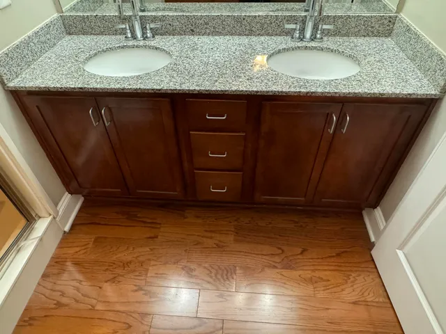 a bathroom with a granite countertop sink and a mirror