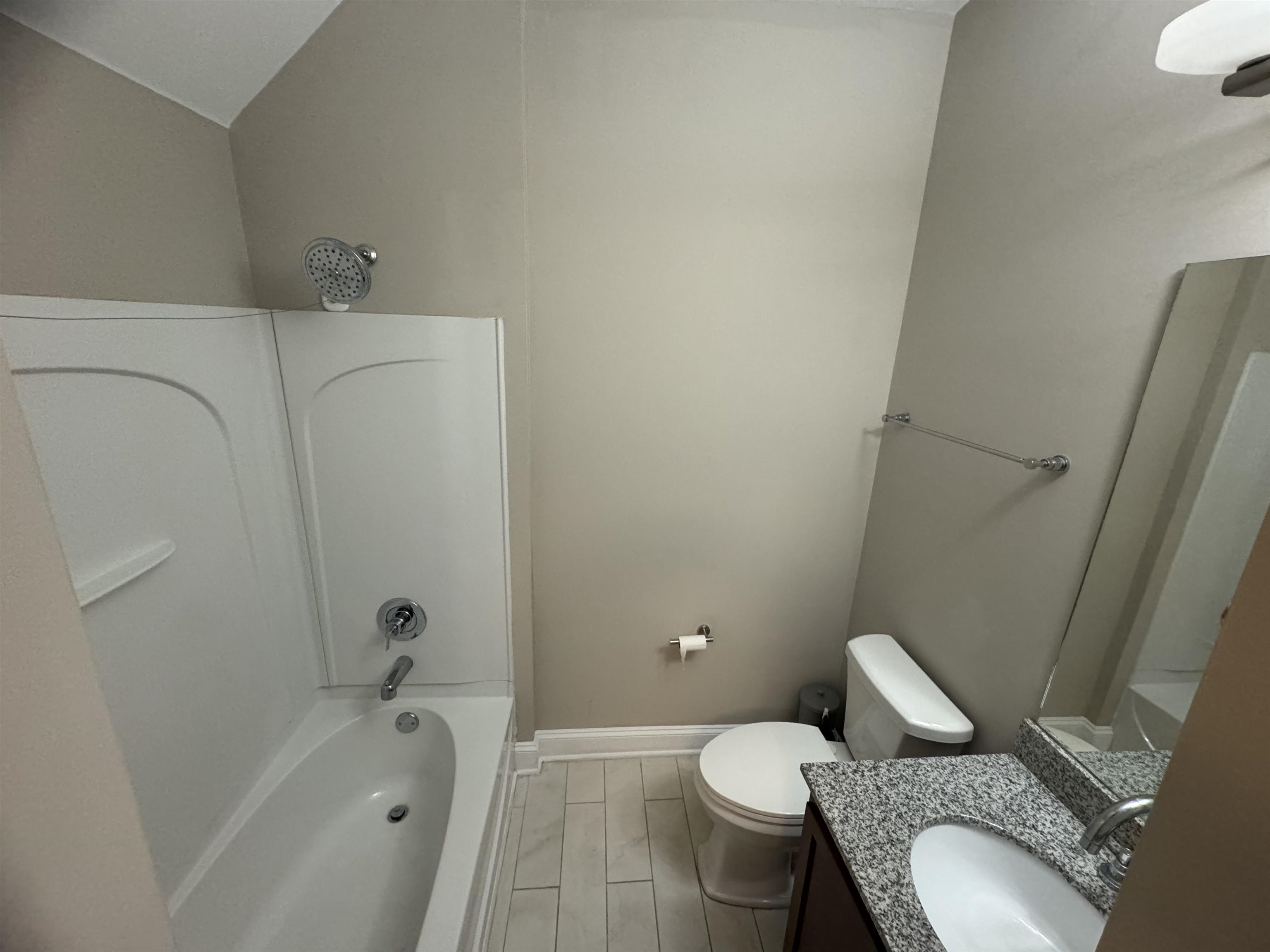 70 West Carolina Avenue, Unit 105 Memphis, TN 38103 - Photo 19 of 40 a white toilet sitting next to a bath tub