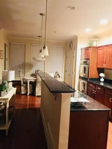 a kitchen with stainless steel appliances granite countertop a sink a stove and a refrigerator