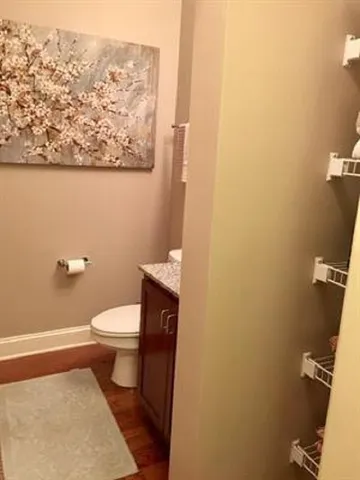 a white toilet sitting next to a shower