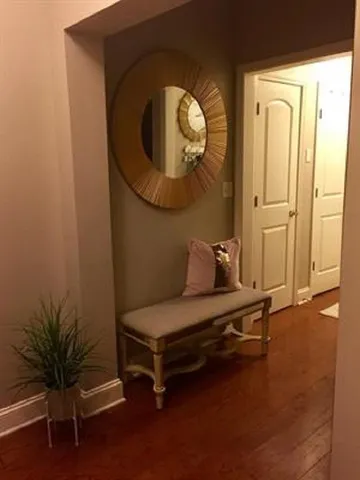 a living room with furniture and a mirror