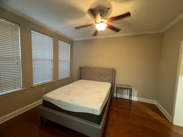a bed sitting in a bedroom next to a window