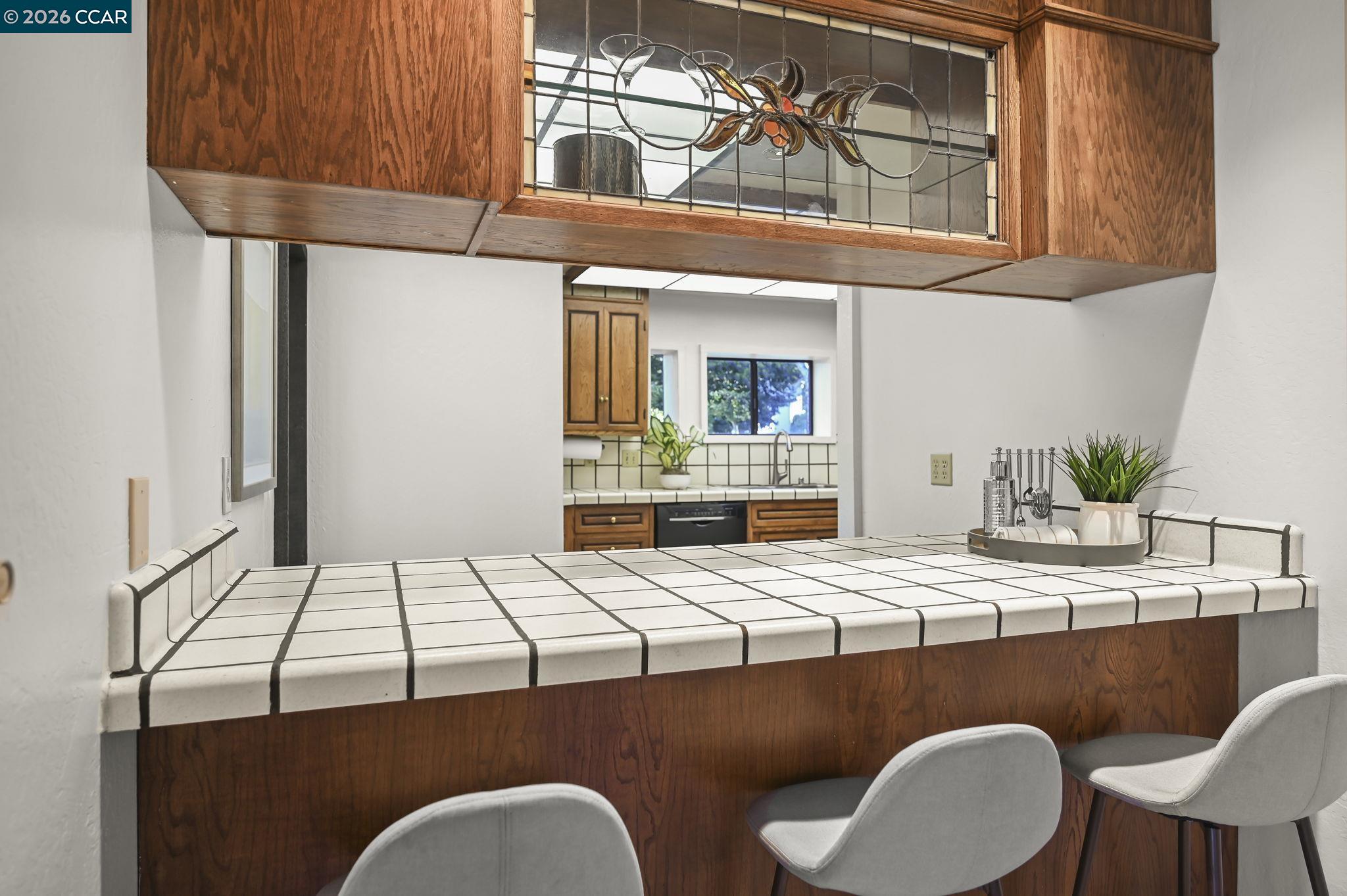 3912 Quail Ridge Road Lafayette, CA 94549 - Photo 14 of 60 a kitchen with a table chairs and white cabinets