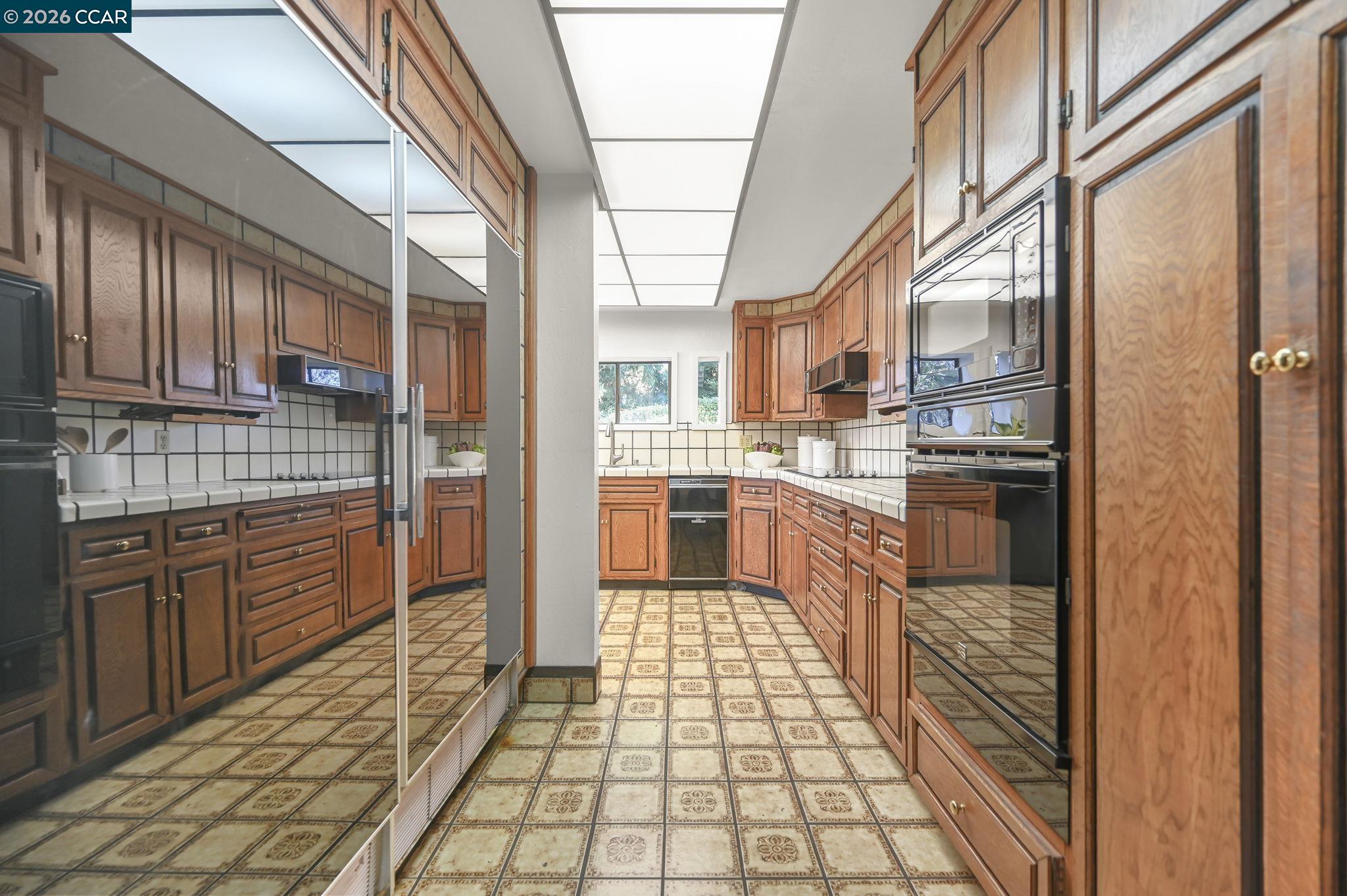 3912 Quail Ridge Road Lafayette, CA 94549 - Photo 15 of 60 a kitchen with stainless steel appliances granite countertop a refrigerator and a stove top oven