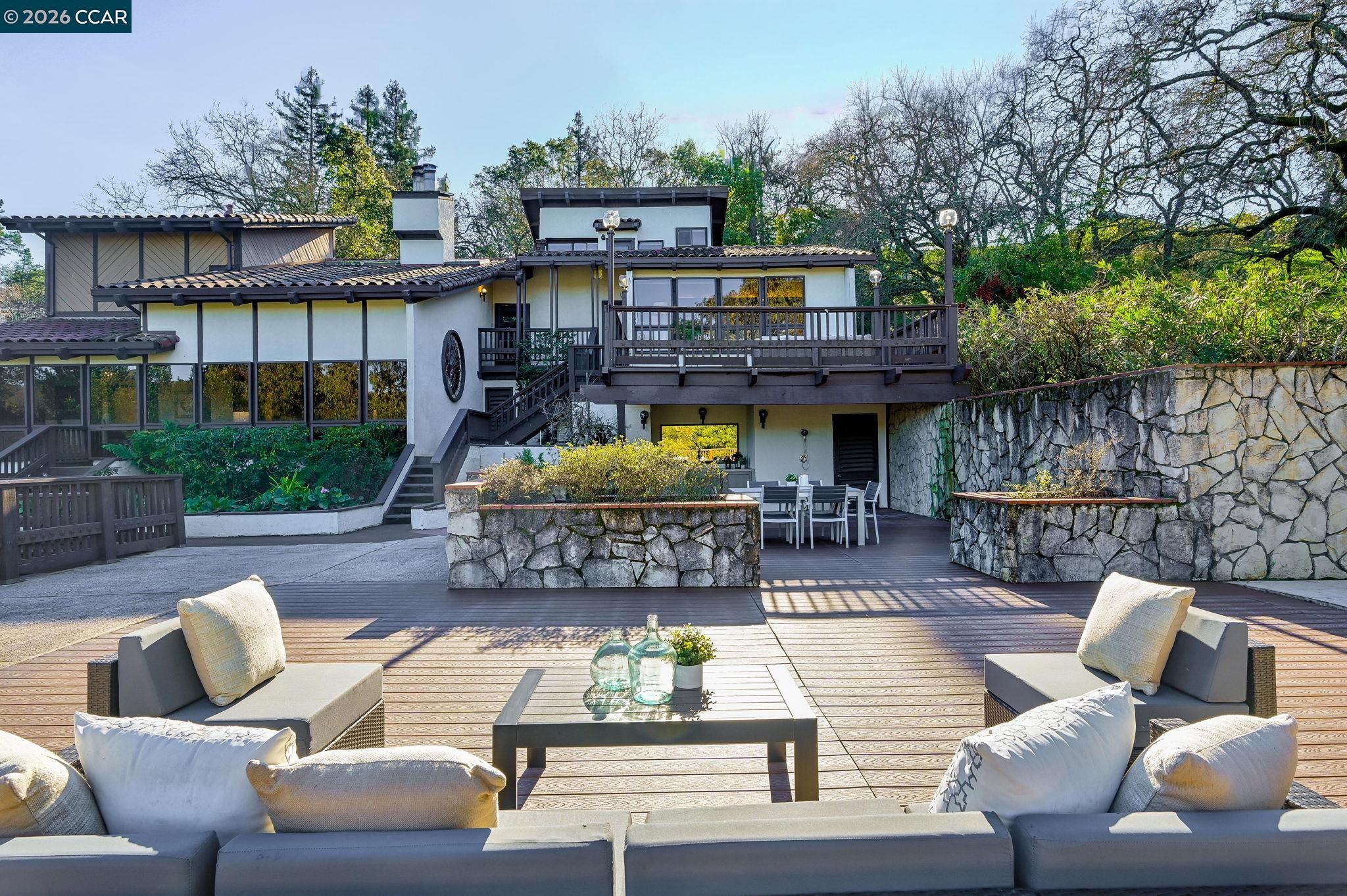 3912 Quail Ridge Road Lafayette, CA 94549 - Photo 46 of 60 a view of a patio with couches table and chairs potted plants and large tree