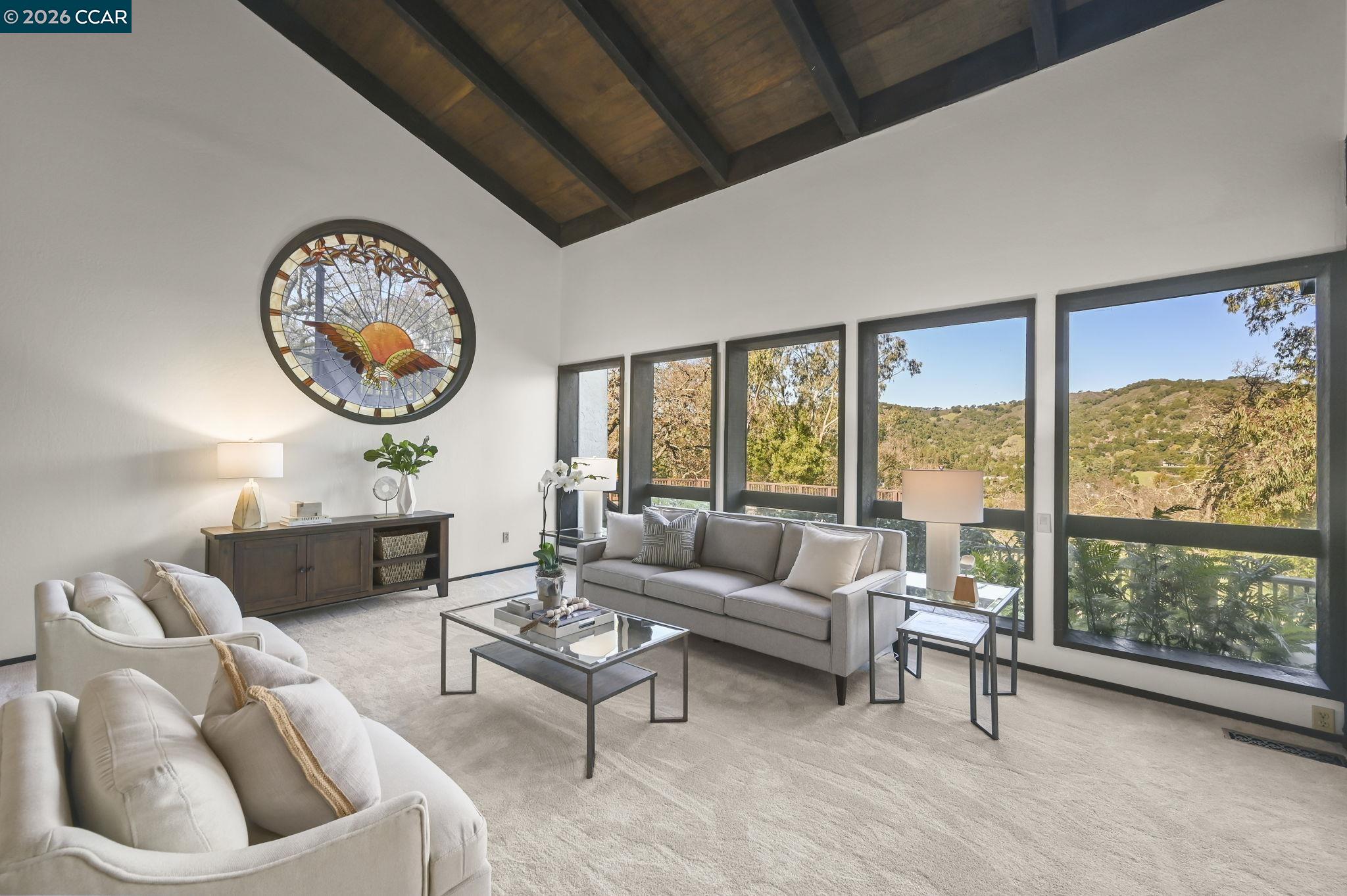 3912 Quail Ridge Road Lafayette, CA 94549 - Photo 6 of 60 a living room with furniture a lamp and a large window