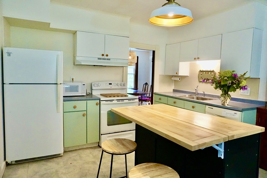 4 Carpenter Road Monson, MA 01057 - Photo 5 of 29 a room with kitchen island a table and chairs