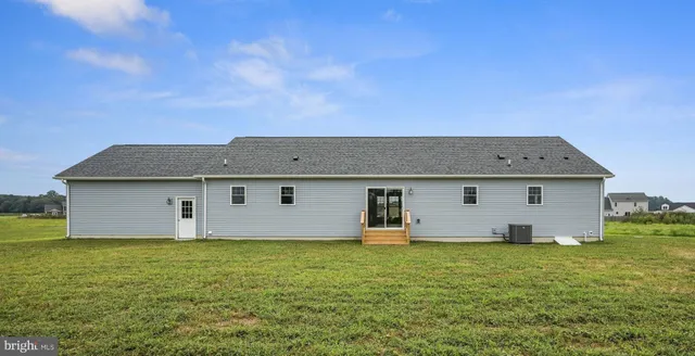 a front view of house with yard and trees
