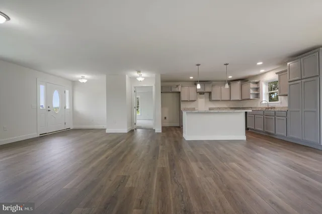 a view of kitchen with wooden floor and windows