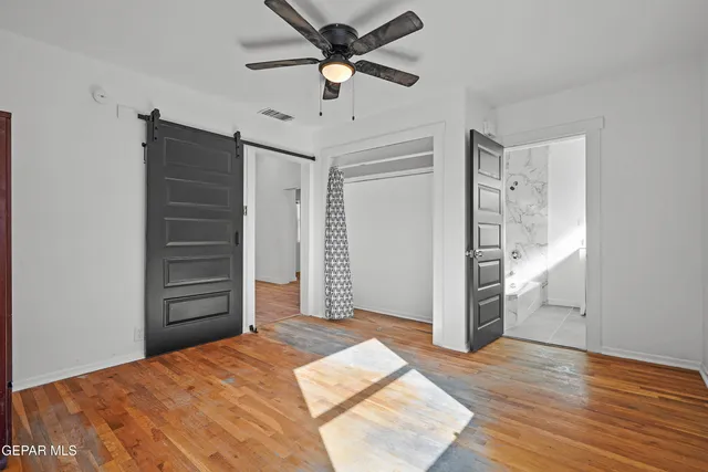 a view of a bedroom with closet and cabinet