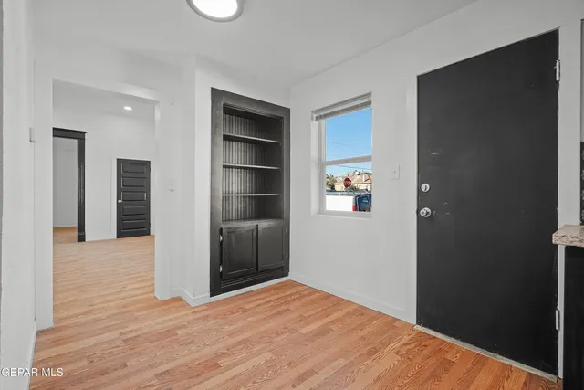 a view of empty room with wooden floor and closet