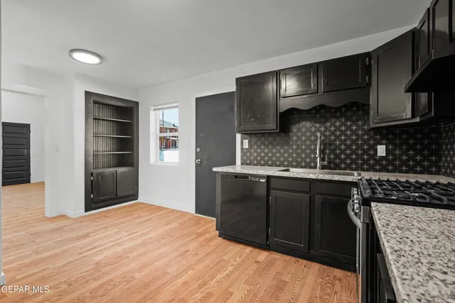 a kitchen with a sink stove and cabinets