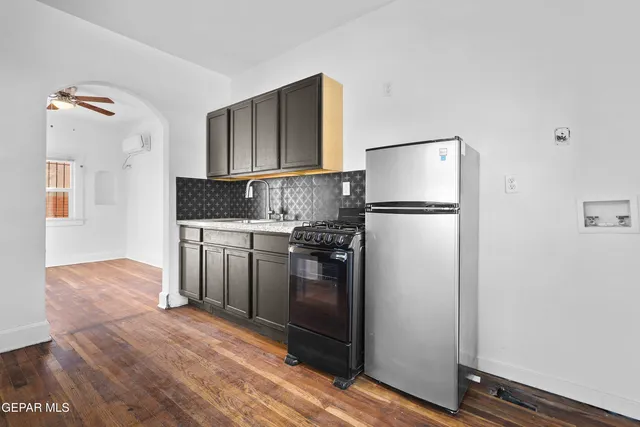 a kitchen with stainless steel appliances granite countertop a refrigerator sink and stove