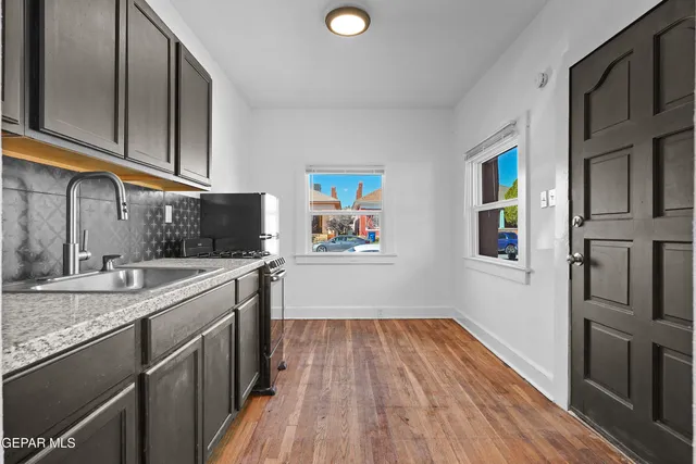 a kitchen with cabinets a sink and wooden floor