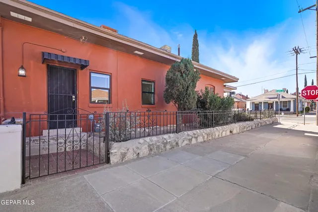 a view of a house with a wooden fence