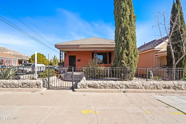 a view of a dinning room with large trees and flower plants