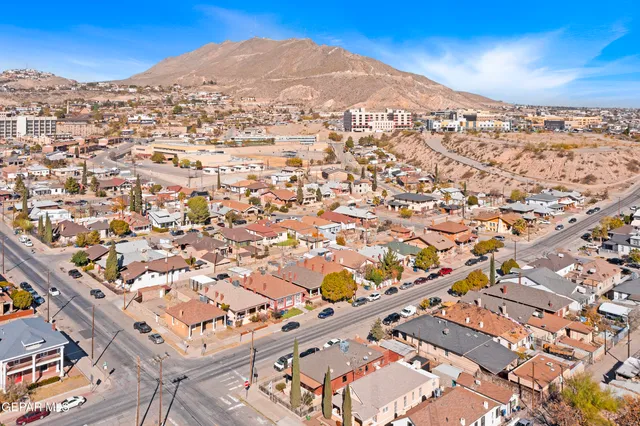 an aerial view of residential houses with city view