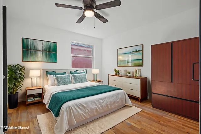 a bedroom with a bed and a dresser