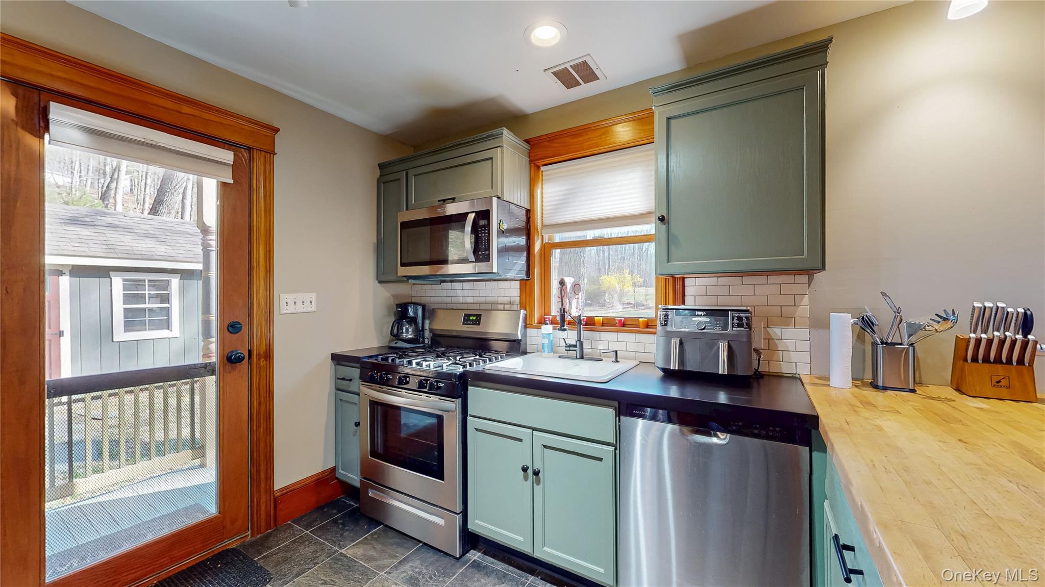 1193 S Road Wurtsboro, NY 12790 - Photo 16 of 41 a kitchen with stainless steel appliances granite countertop a sink stove and cabinets