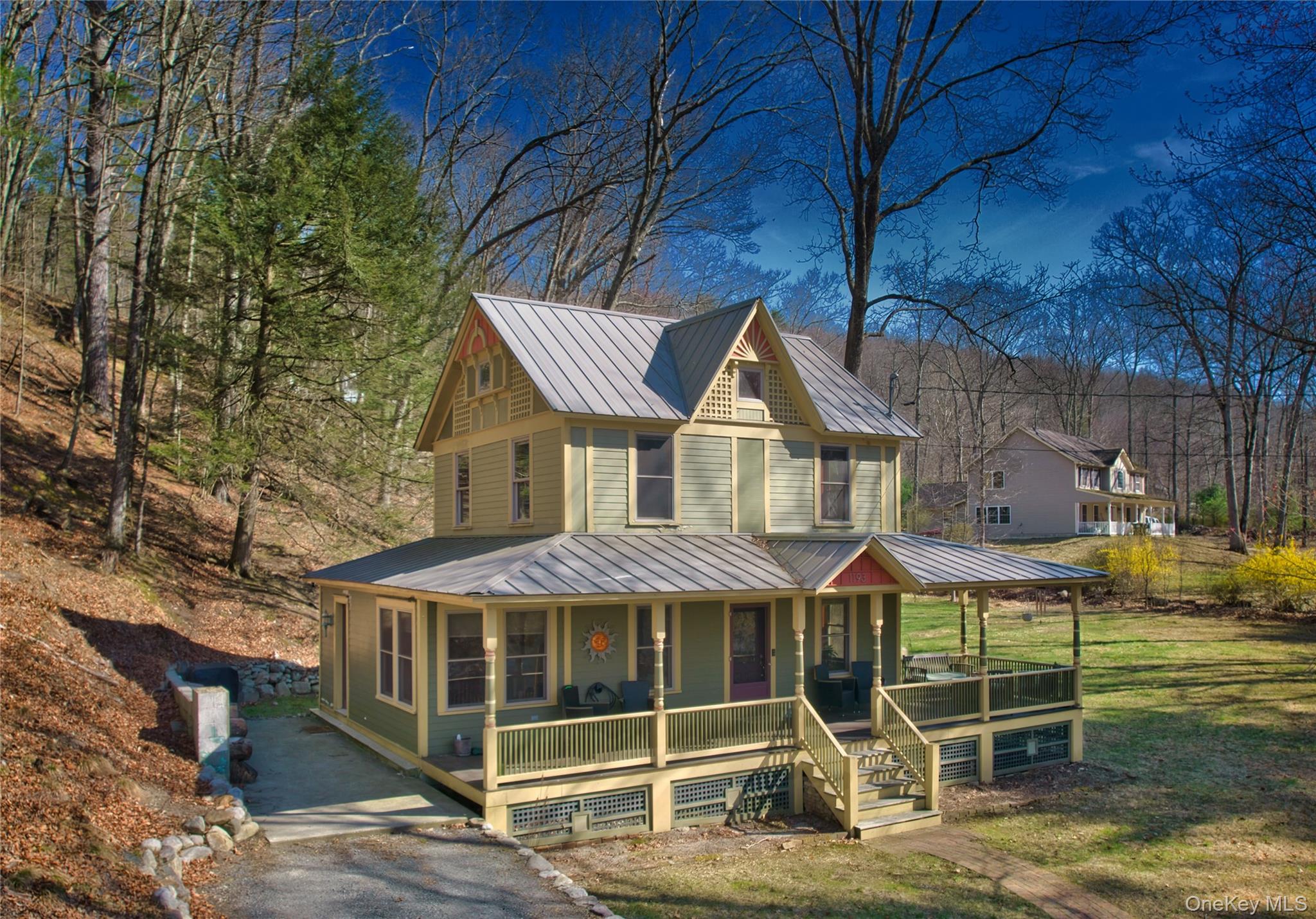 1193 S Road Wurtsboro, NY 12790 - Photo 2 of 41 a view of a house with large windows and a yard with wooden fence