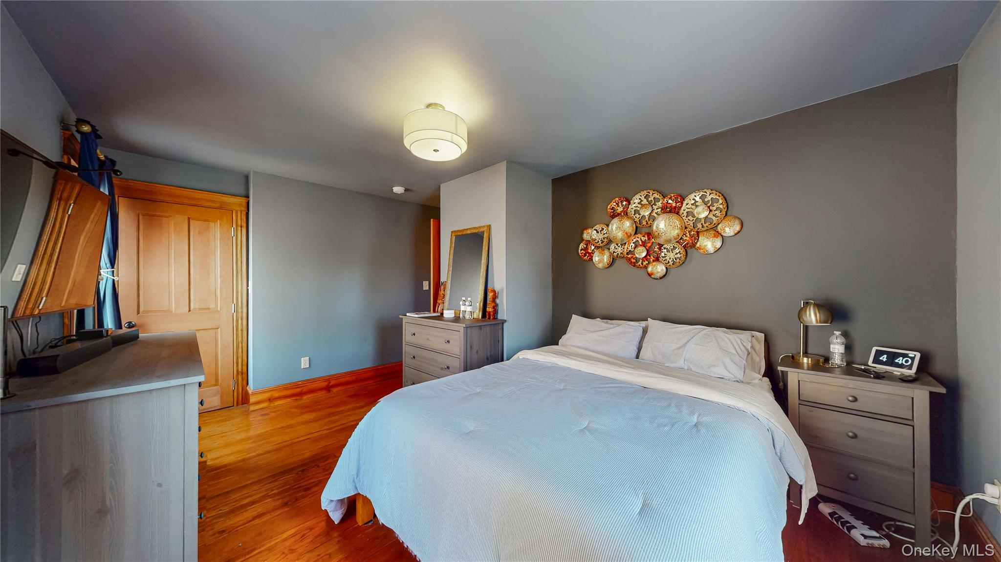 1193 S Road Wurtsboro, NY 12790 - Photo 29 of 41 a bedroom with a bed and a flat tv screen on dresser