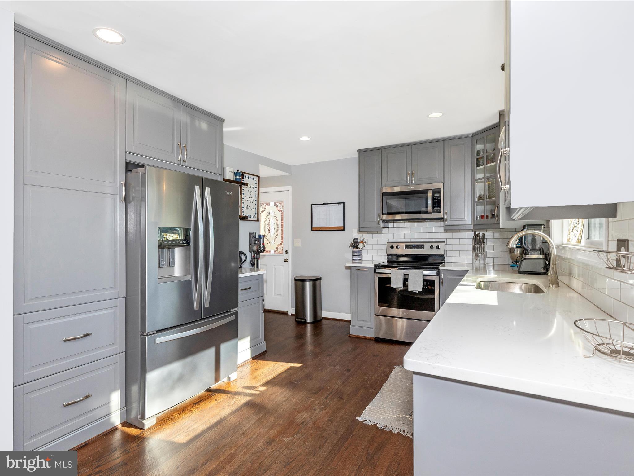 207 Thomas Avenue Frederick, MD 21701 - Photo 12 of 60 a kitchen with granite countertop a refrigerator stove and sink