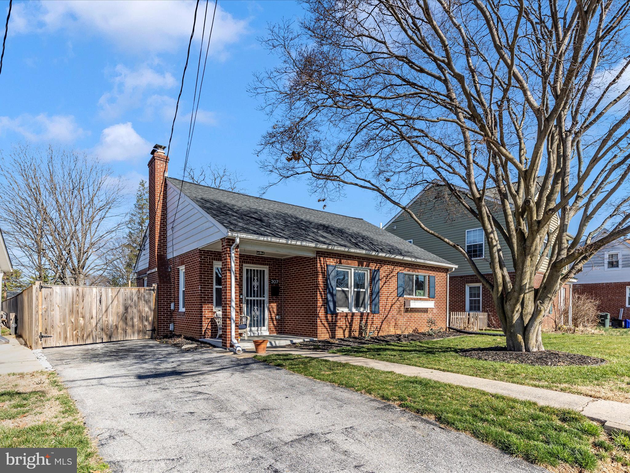 207 Thomas Avenue Frederick, MD 21701 - Photo 45 of 60 a view of a brick house with large windows and a large tree
