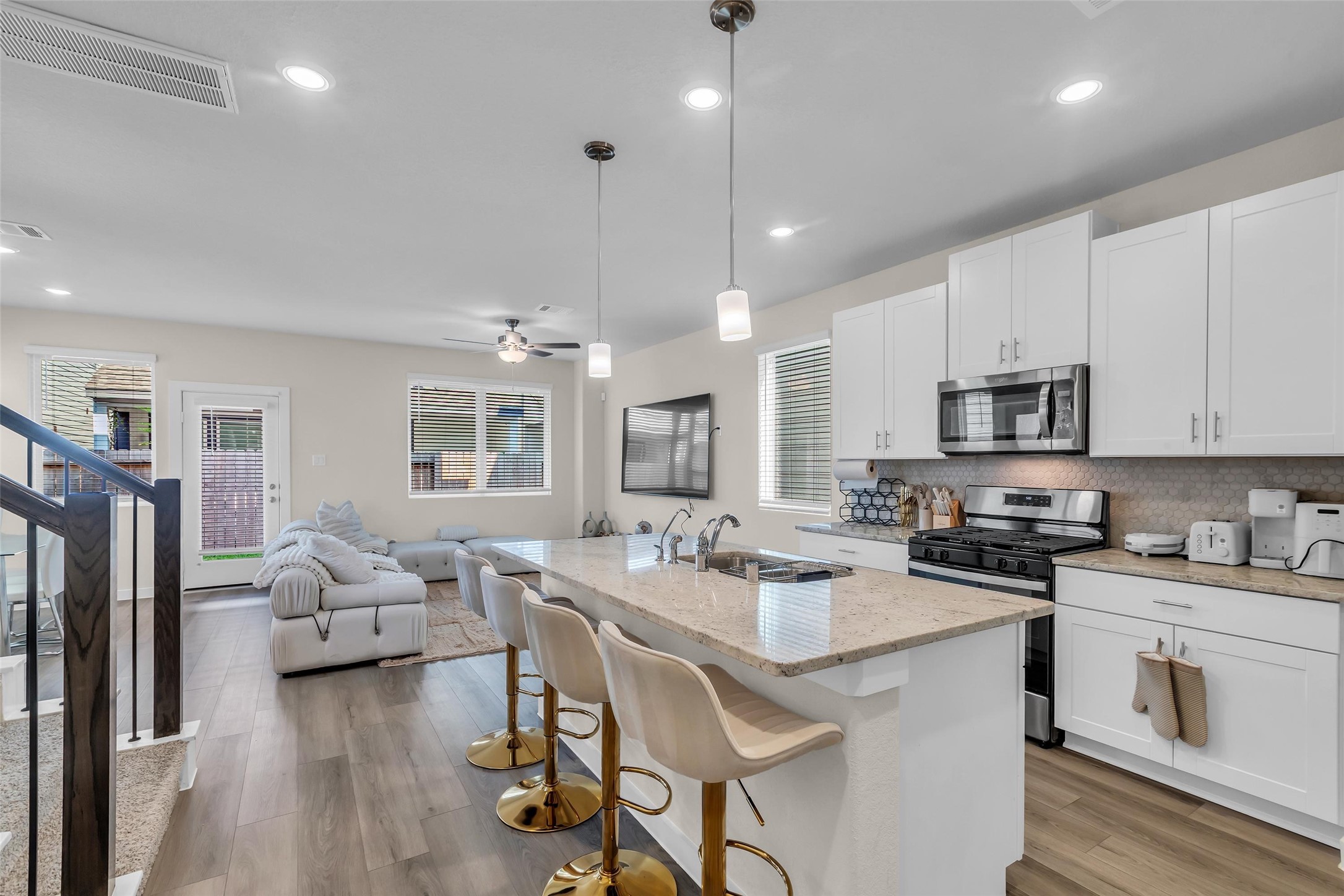 3109 Boulder Rnch Drive Houston, TX 77063 - Photo 6 of 15 a kitchen with stainless steel appliances granite countertop a stove top oven a sink dishwasher a dining table and chairs with wooden floor