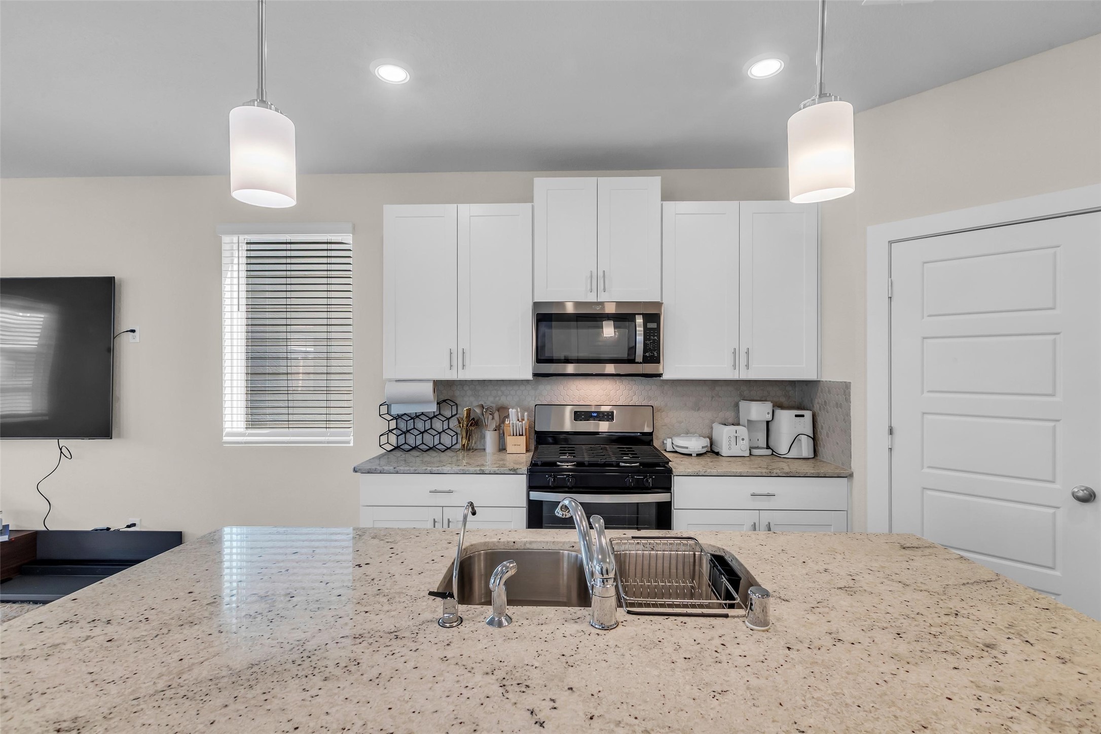 3109 Boulder Rnch Drive Houston, TX 77063 - Photo 10 of 15 a kitchen with stainless steel appliances granite countertop a sink a stove a microwave a refrigerator and cabinets