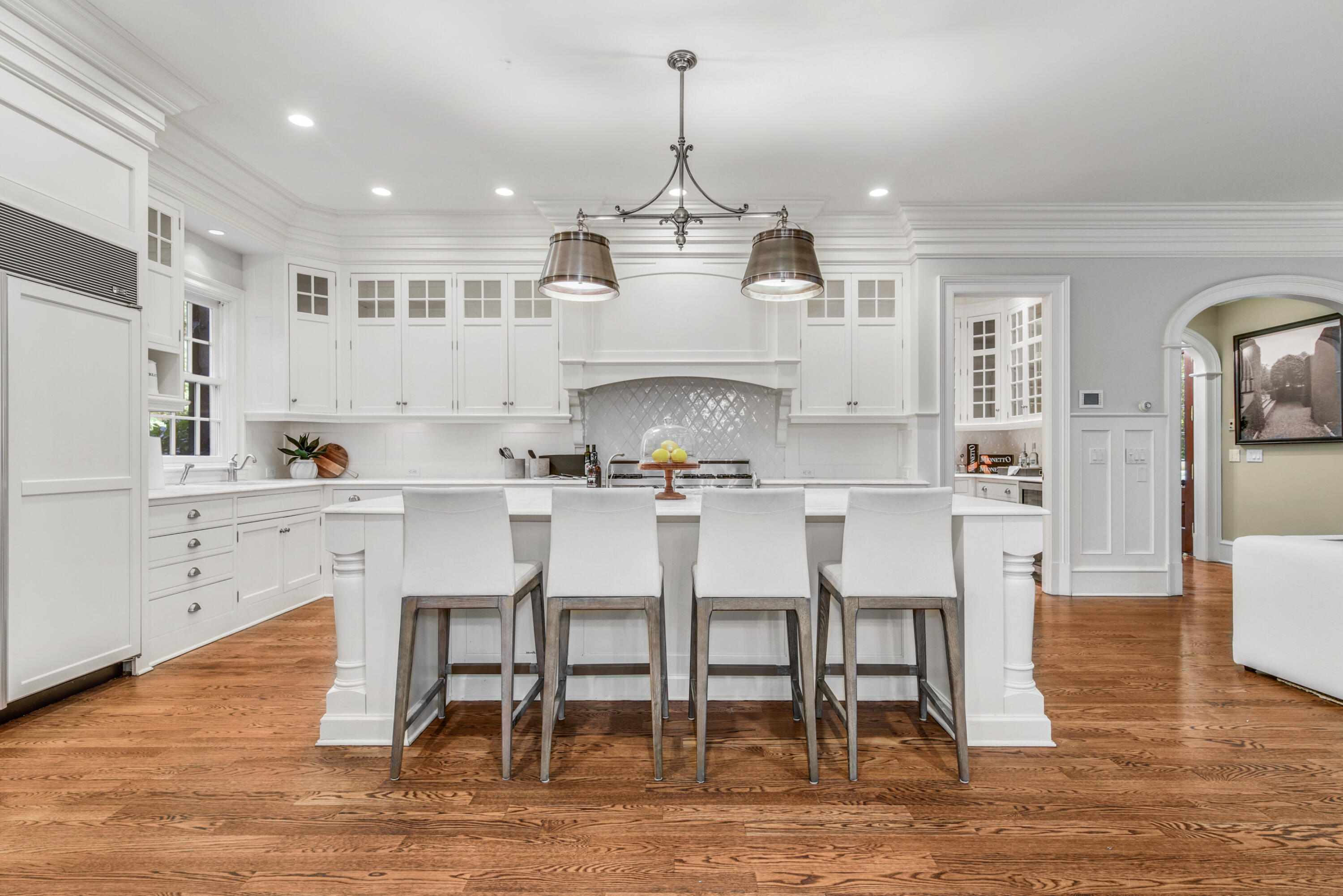 183 Ferris Hill Road New Canaan, CT 06840 - Photo 12 of 40 a kitchen with stainless steel appliances kitchen island granite countertop a dining table chairs and white cabinets