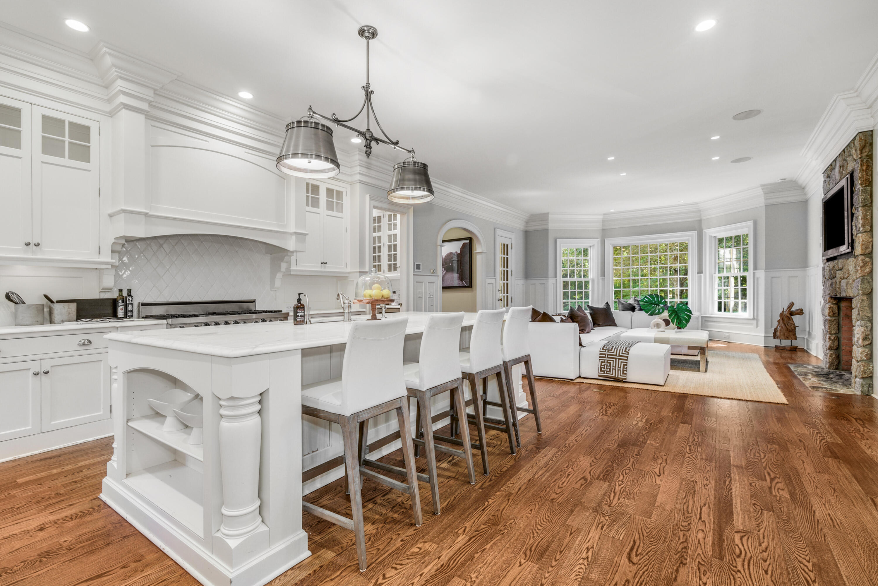 183 Ferris Hill Road New Canaan, CT 06840 - Photo 15 of 40 a kitchen with stainless steel appliances granite countertop a stove top oven a refrigerator a sink dishwasher a dining table and chairs with wooden floor