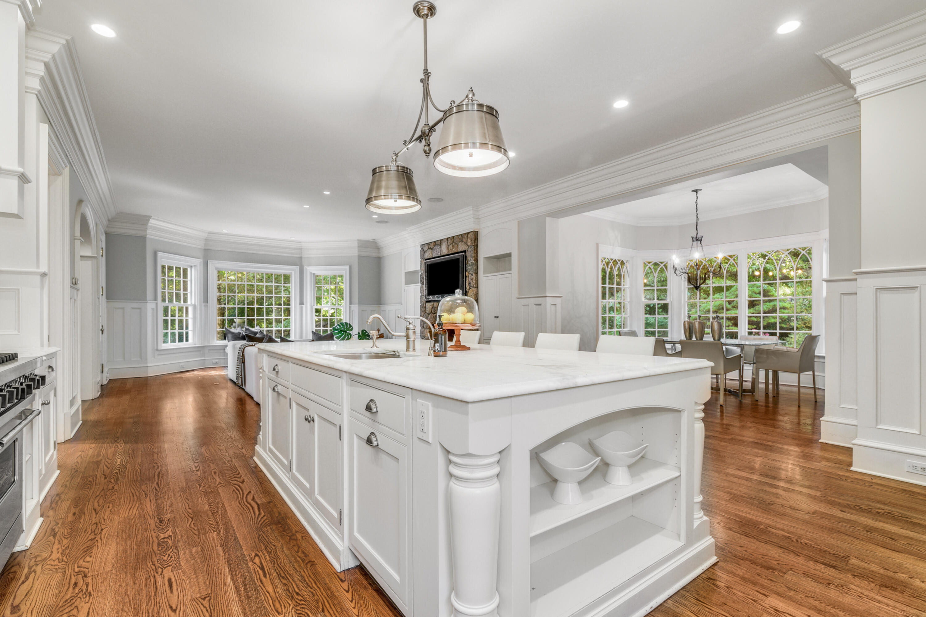 183 Ferris Hill Road New Canaan, CT 06840 - Photo 17 of 40 a large white kitchen with large windows and a chandelier