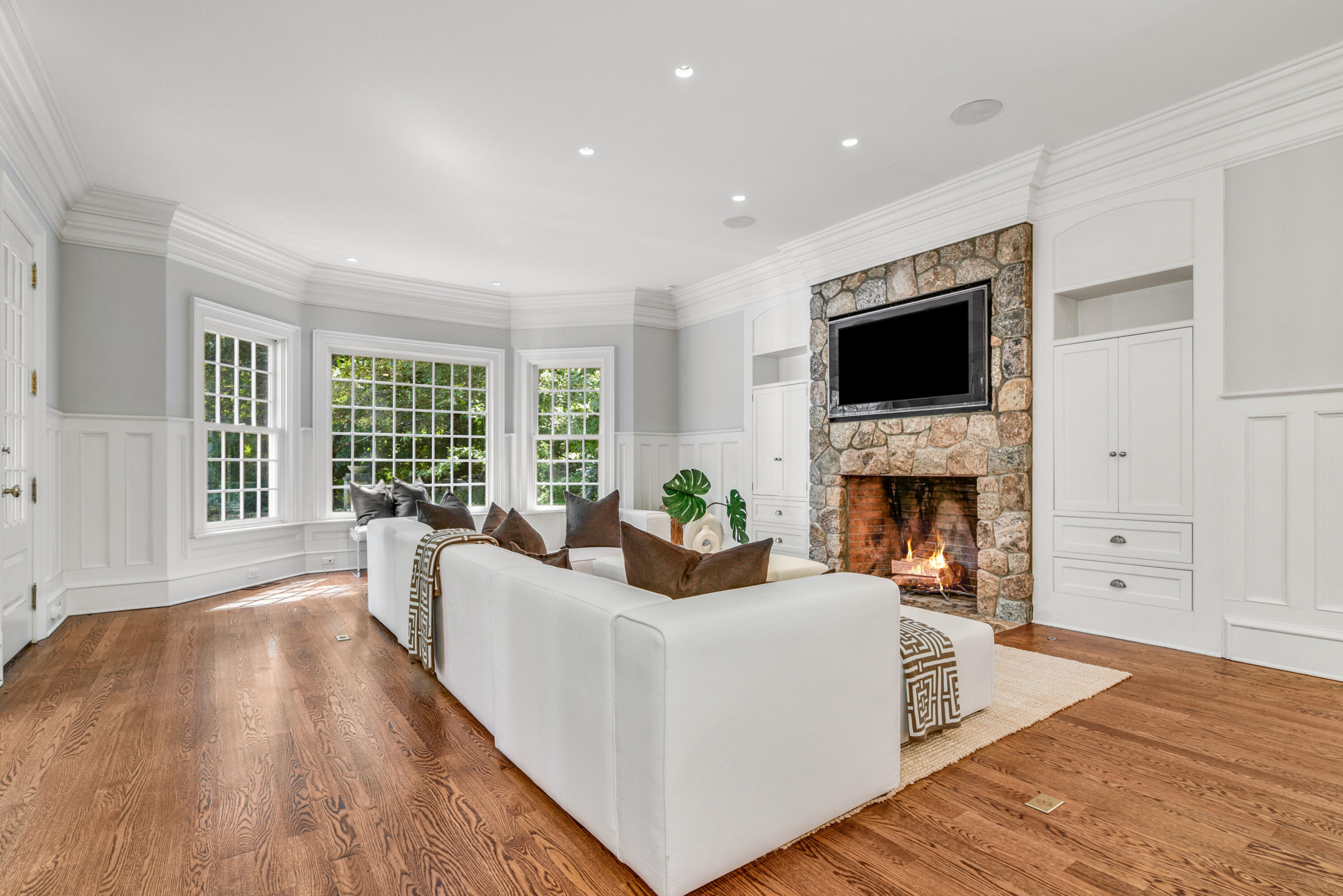 183 Ferris Hill Road New Canaan, CT 06840 - Photo 19 of 40 a living room with fireplace furniture and a flat screen tv