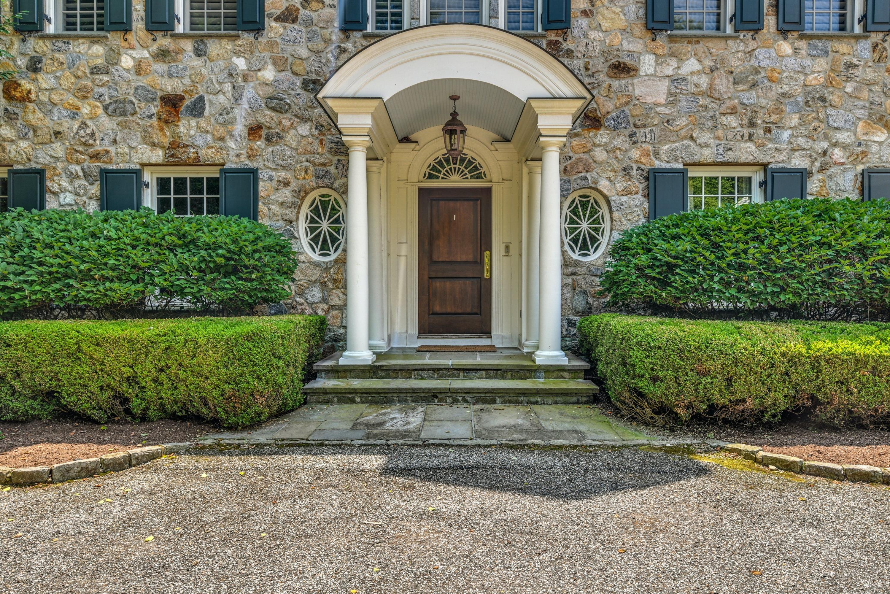 183 Ferris Hill Road New Canaan, CT 06840 - Photo 3 of 40 front view of a house with a garden