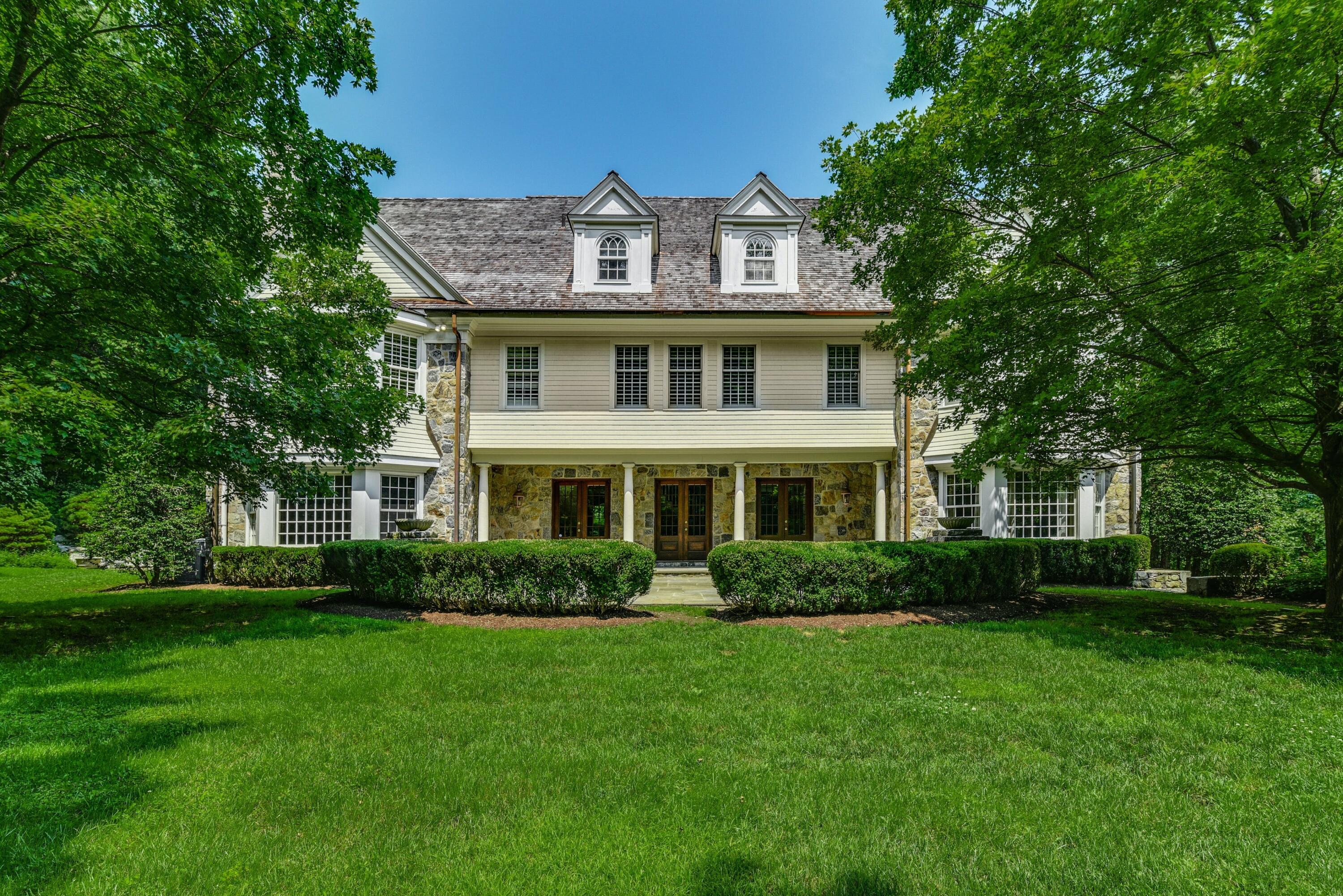 183 Ferris Hill Road New Canaan, CT 06840 - Photo 31 of 40 a front view of a house with a garden