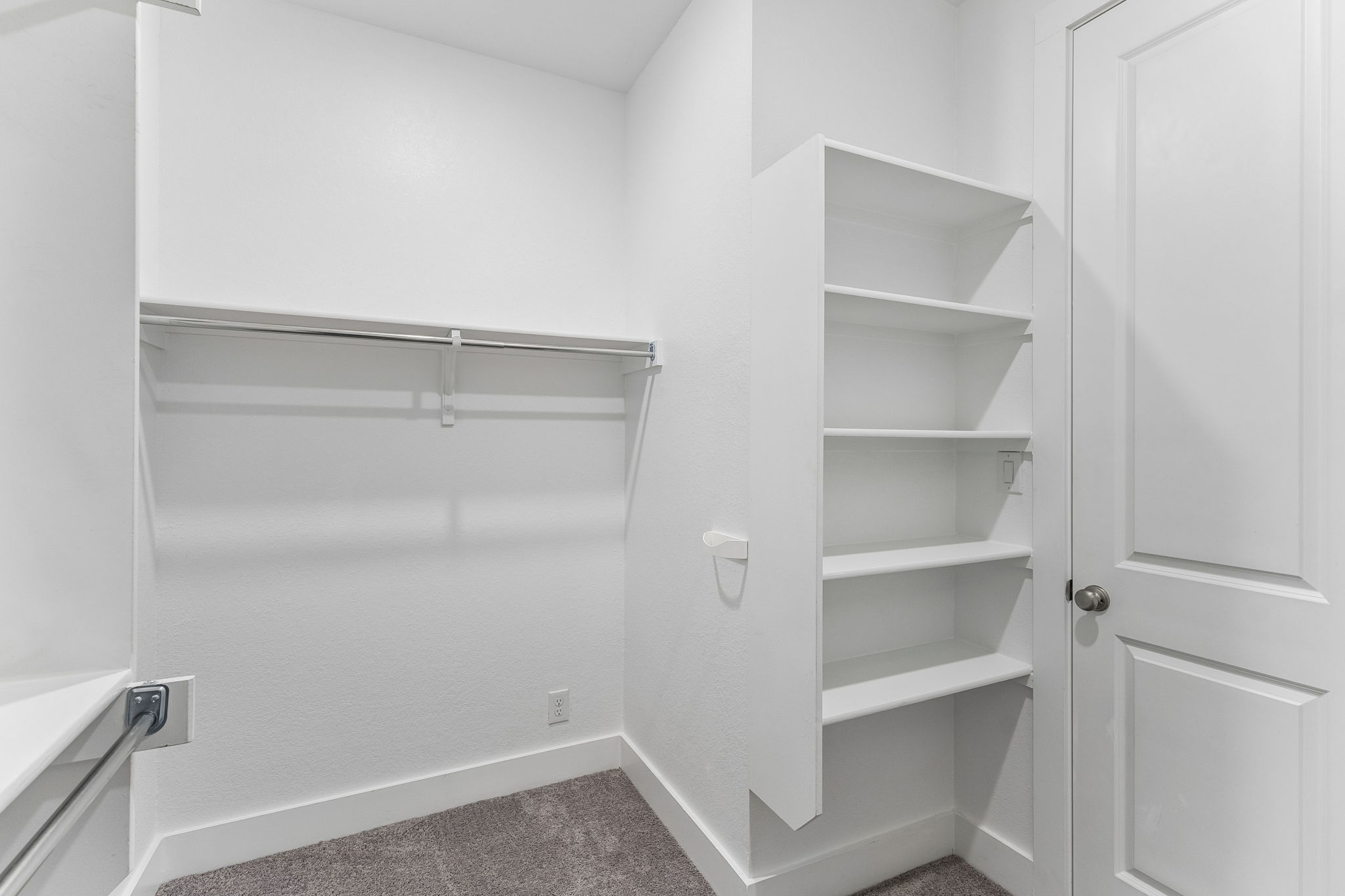 228 Arrowhead Mound Road Georgetown, TX 78628 - Photo 17 of 34 Functional walk-in closet featuring ample shelving and a hanging rod for organized storage.