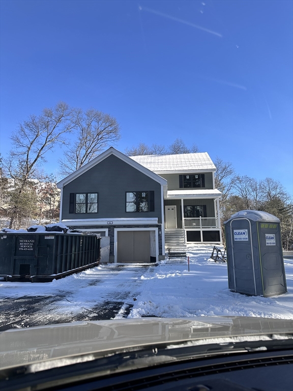 a view of a house with a wooden fence