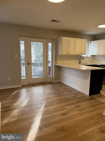 a view of kitchen with granite countertop cabinets and outdoor space