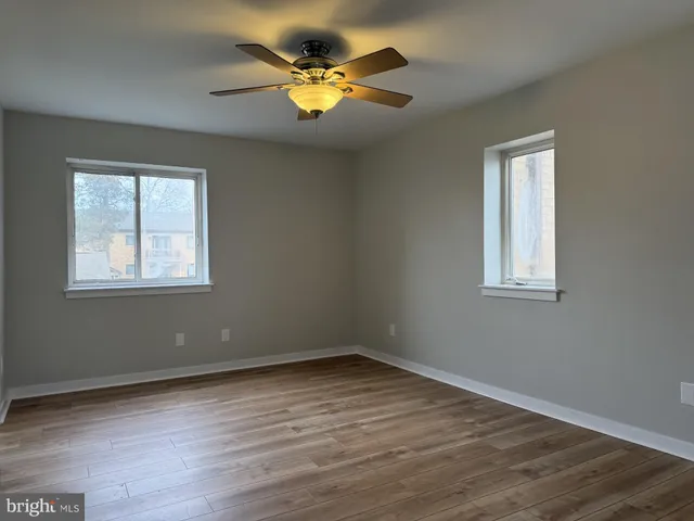 a view of a room with wooden floor and a window