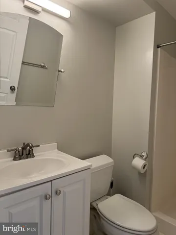 a bathroom with a sink a toilet and mirror
