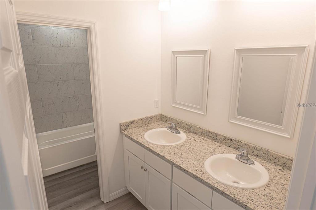 561 Wildmer Road Southwest Palm Bay, FL 32908 - Photo 13 of 19 a bathroom with a granite countertop sink and a mirror