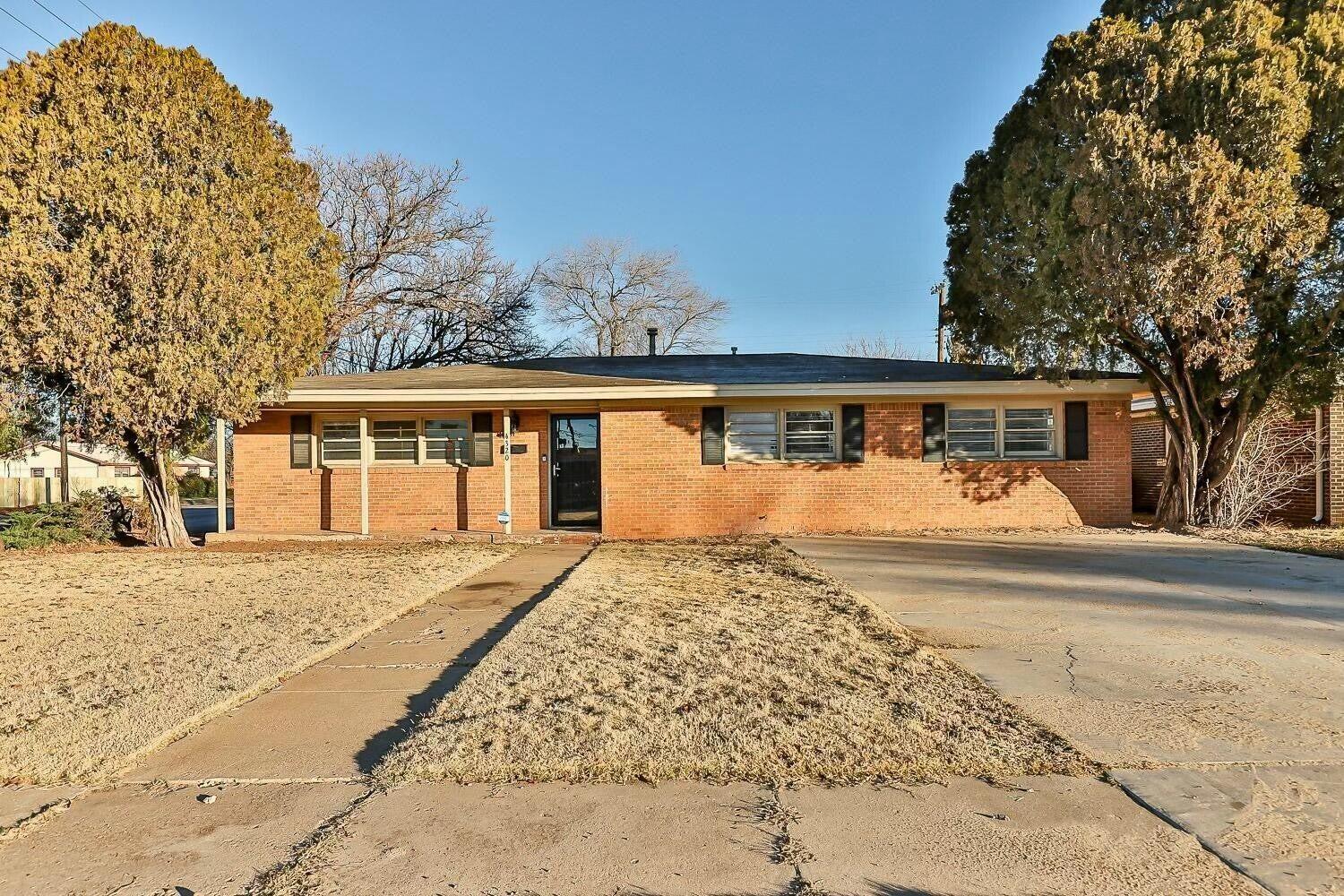 4320 48th Street Lubbock, TX 79413 - Photo 1 of 17 a view of backyard with large trees