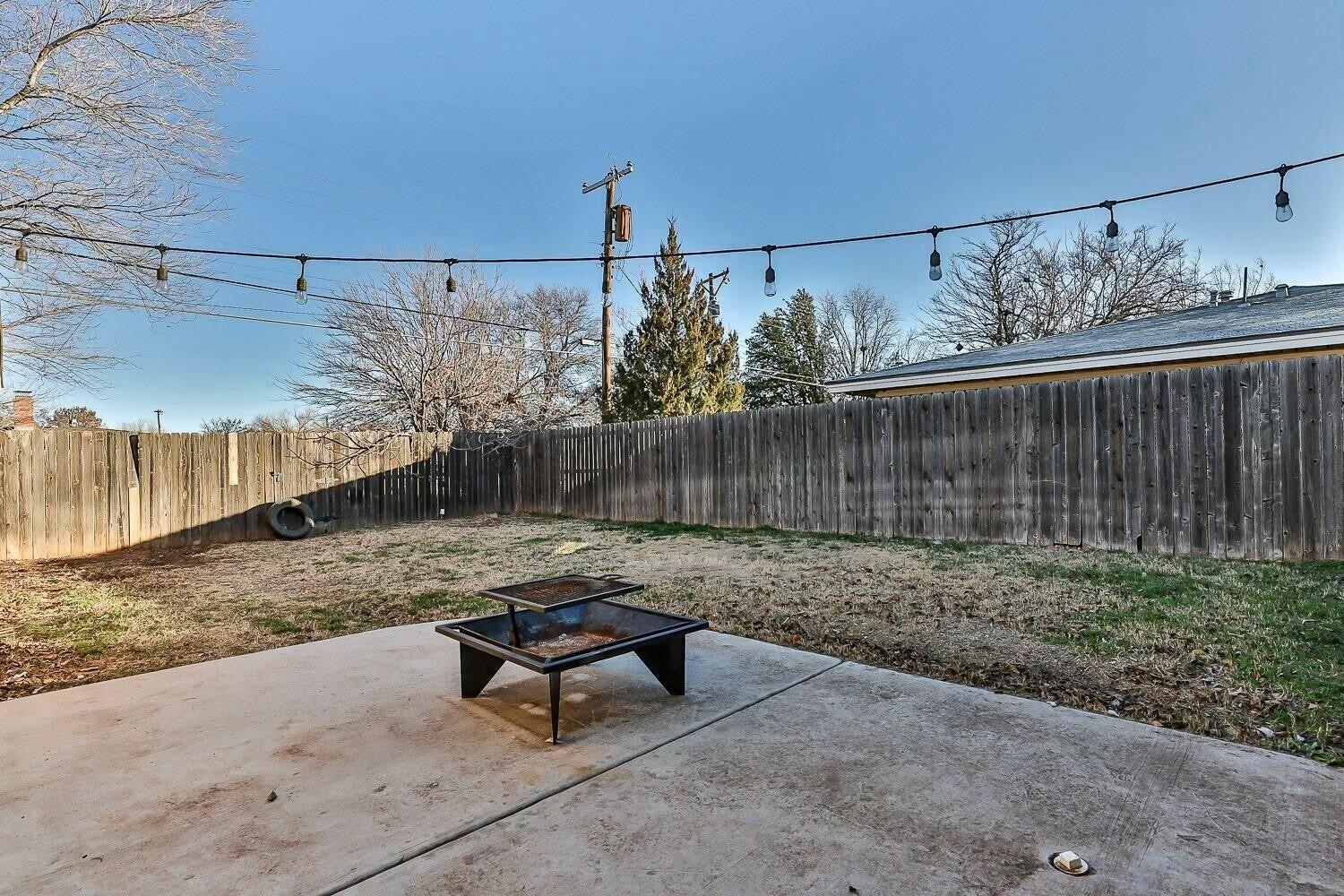 4320 48th Street Lubbock, TX 79413 - Photo 15 of 17 a view of a backyard with plants and outdoor seating