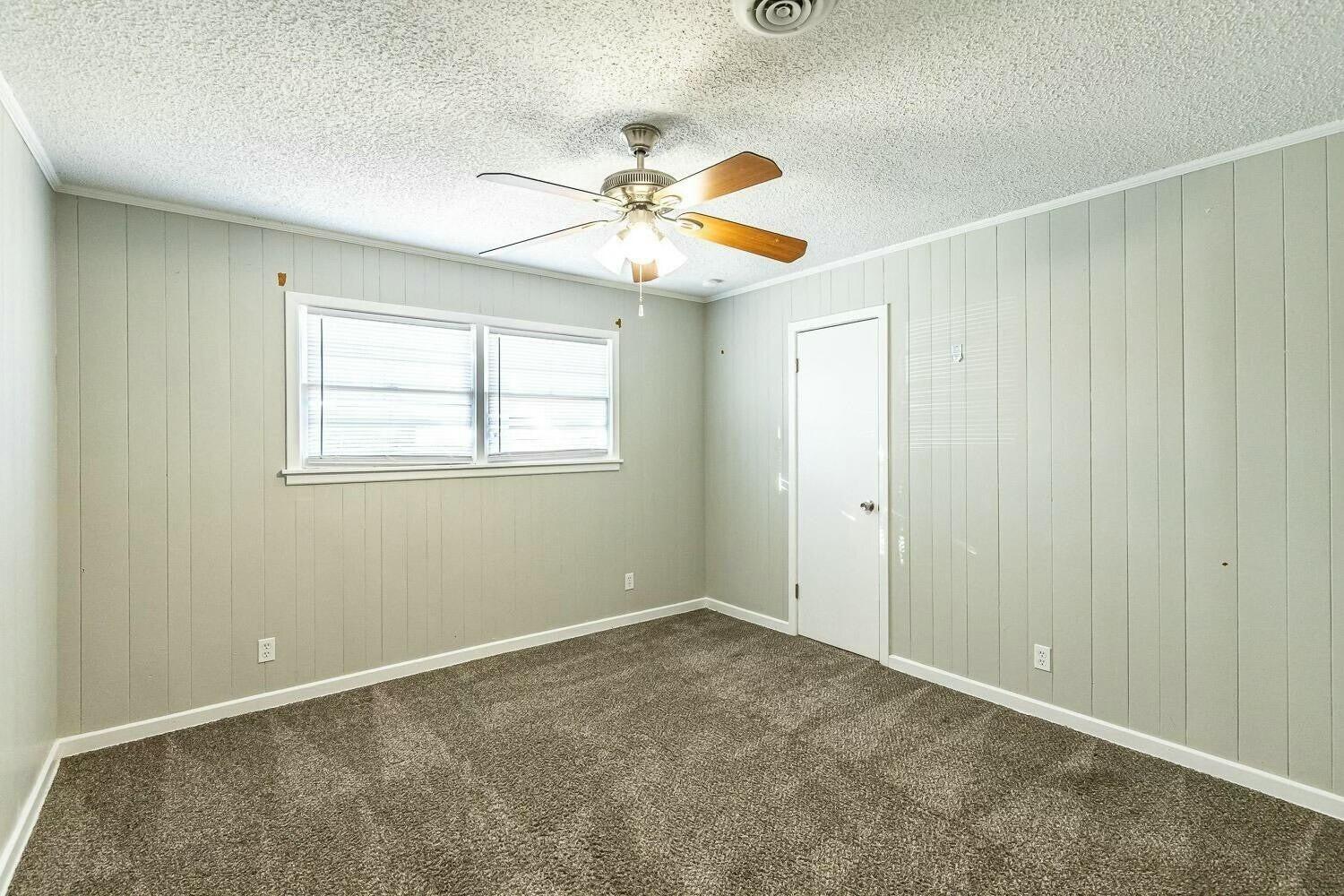 4320 48th Street Lubbock, TX 79413 - Photo 9 of 17 an empty room with windows and fan