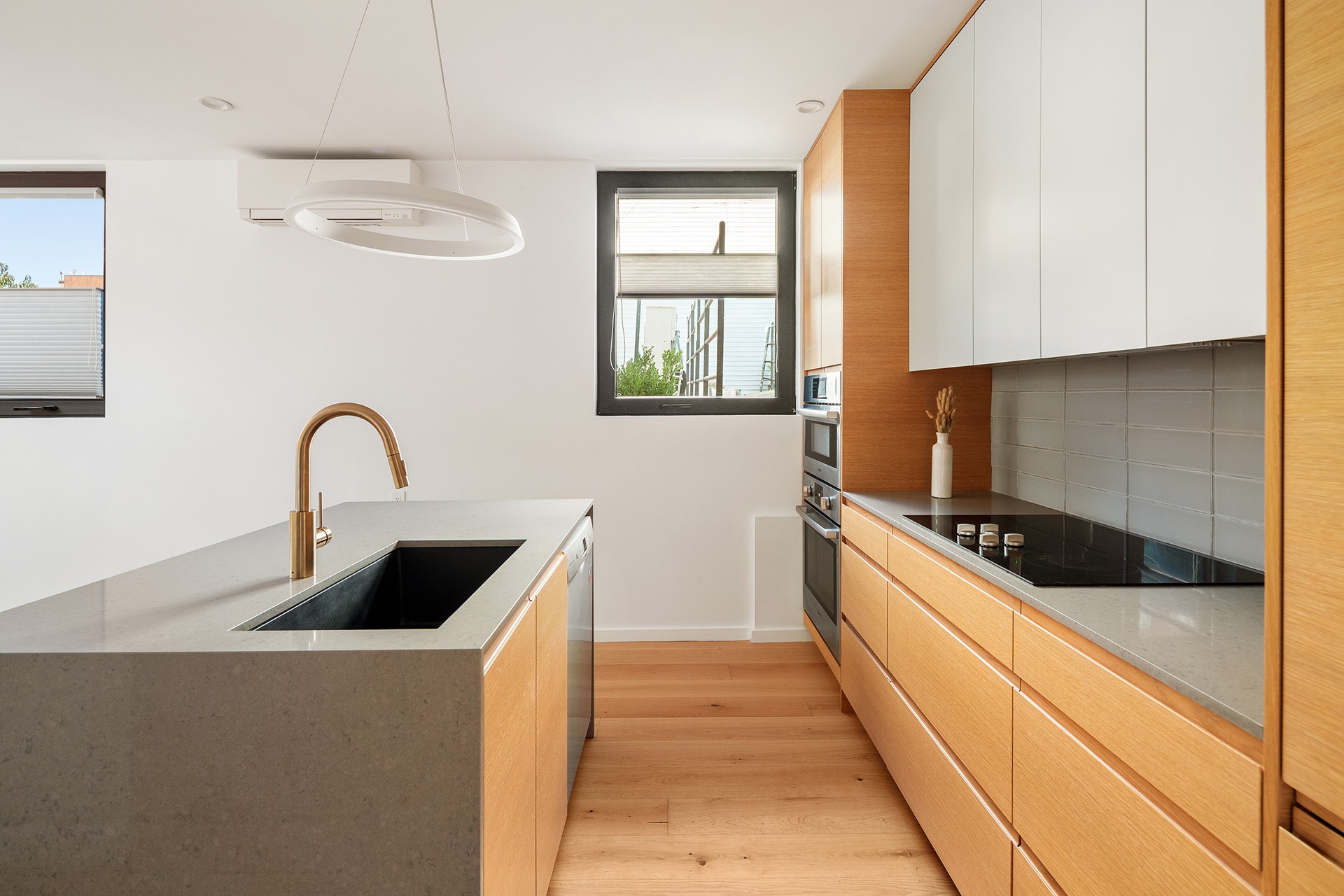 20-48 Steinway Street, Unit 1B Queens, NY 11105 - Photo 2 of 10 a kitchen with stainless steel appliances granite countertop a sink a stove and a window