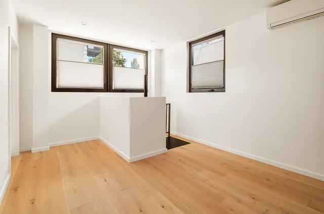 a kitchen with stainless steel appliances granite countertop a sink a stove and a window
