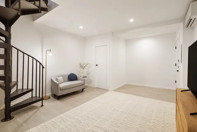 a bathroom with a tub a sink and a mirror