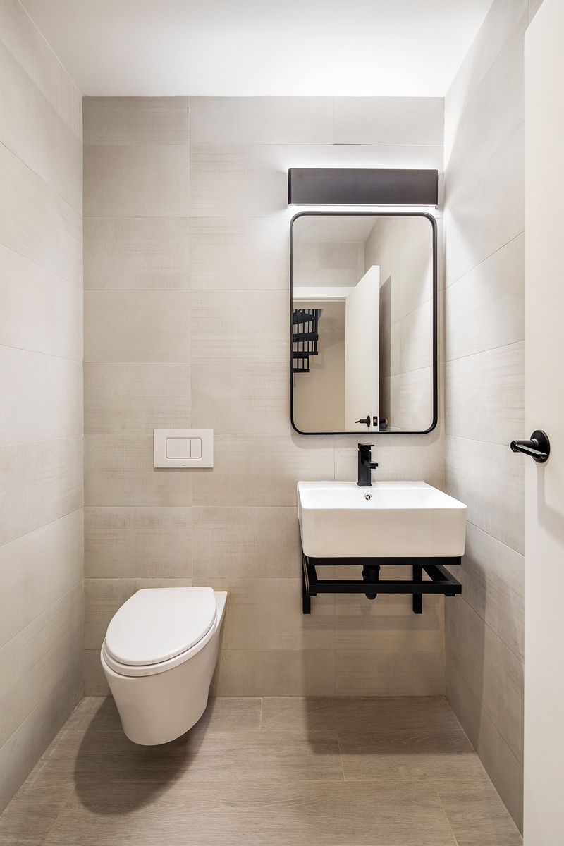 20-48 Steinway Street, Unit 1B Queens, NY 11105 - Photo 8 of 10 a bathroom with a toilet a sink and mirror