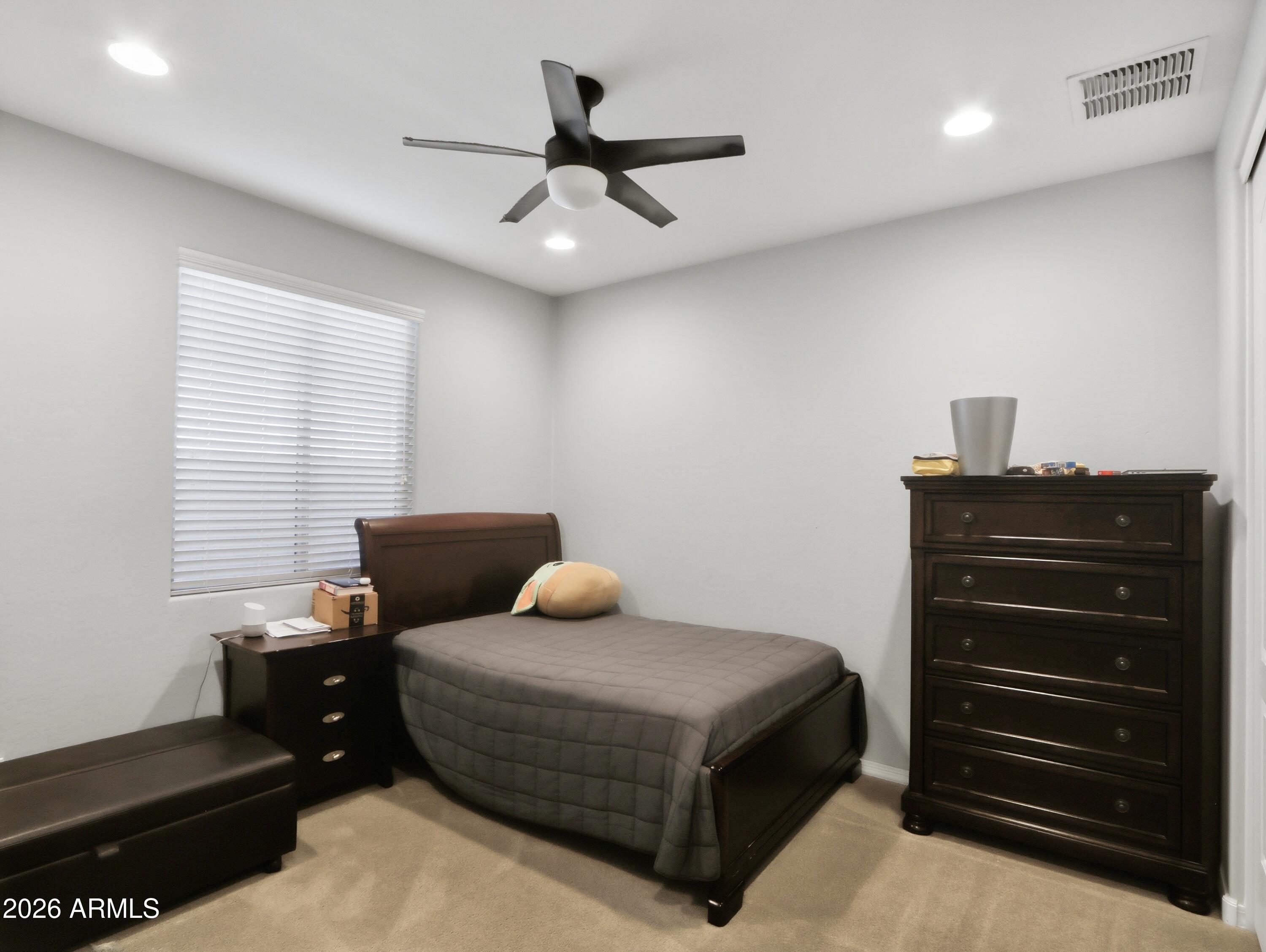 6421 Roy Rogers Road Phoenix, AZ 85083 - Photo 7 of 17 a bedroom with a bed and a ceiling fan