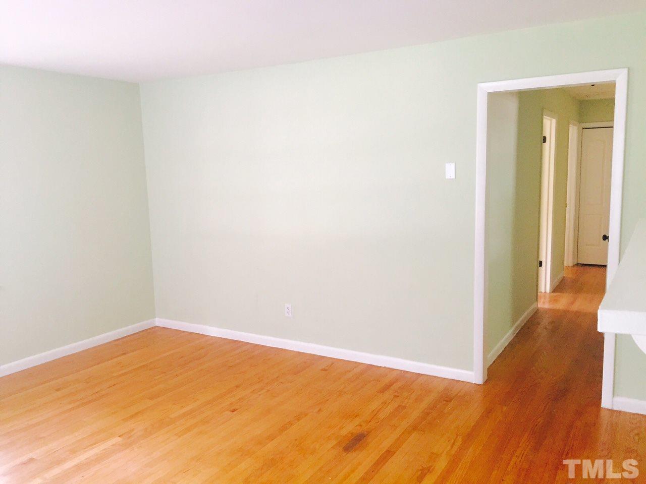 2706 Milburnie Road Raleigh, NC 27610 - Photo 2 of 8 a view of empty room with wooden floor